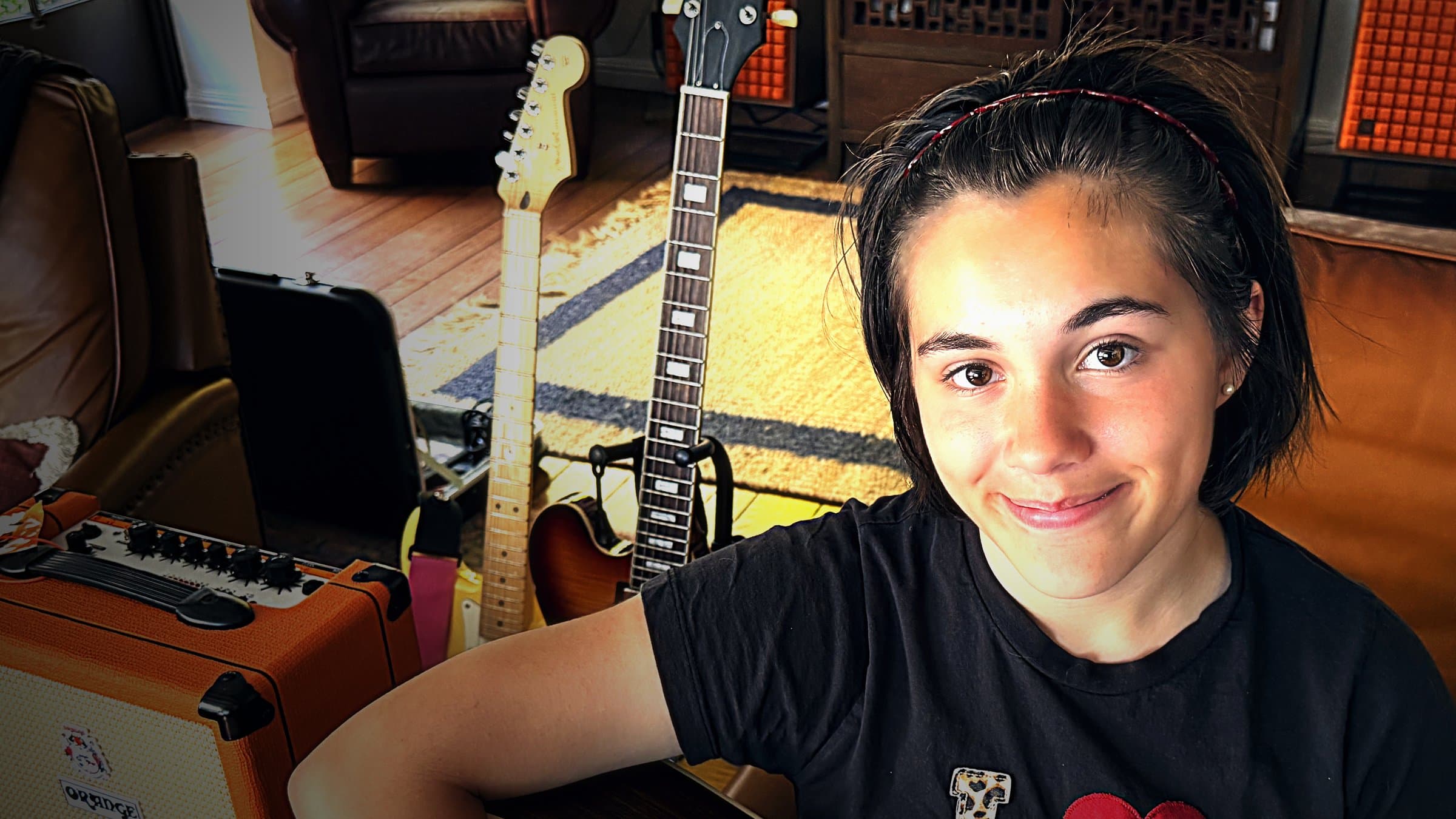 Sloane holding an acoustic guitar